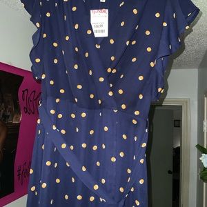 COPY - Gold polkadot dress with a blue background.